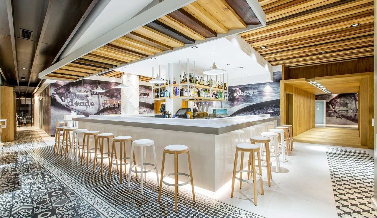 The bar at El Campero, with tall stools and a tiled floor