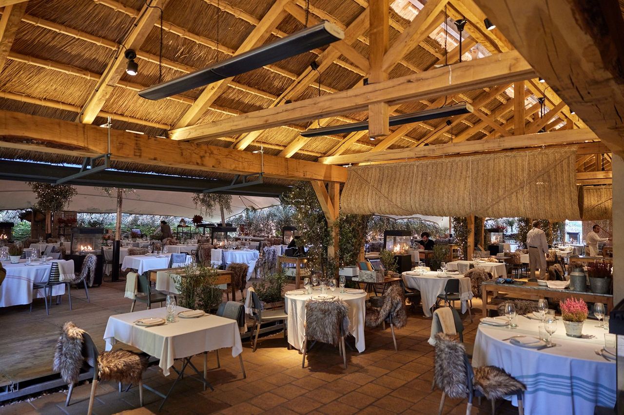 The dining room at Filandón, under a timber-and-reed roof