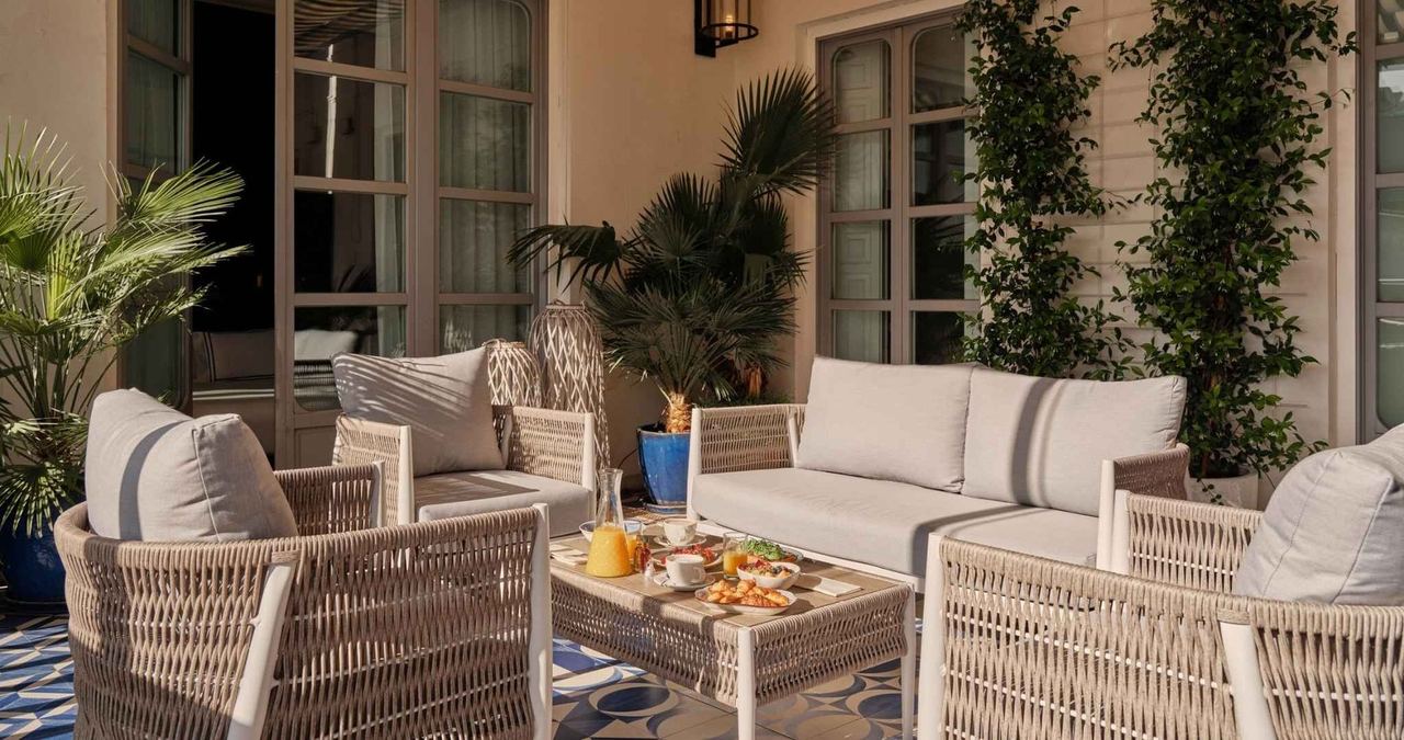 The terrace of Only YOU Boutique Hotel Madrid, laid for breakfast among palms
