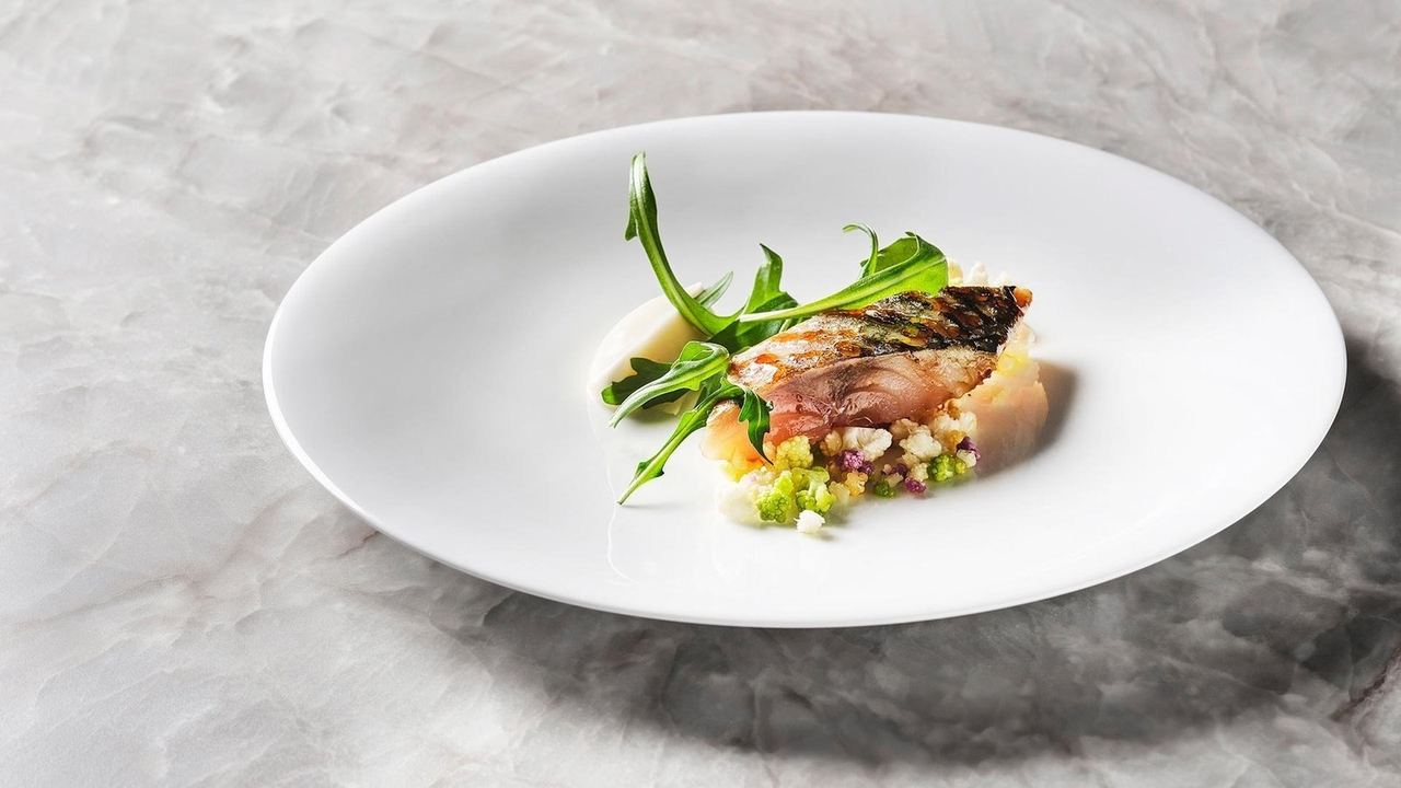 A grilled fish dish at VelascoAbellà on a white plate